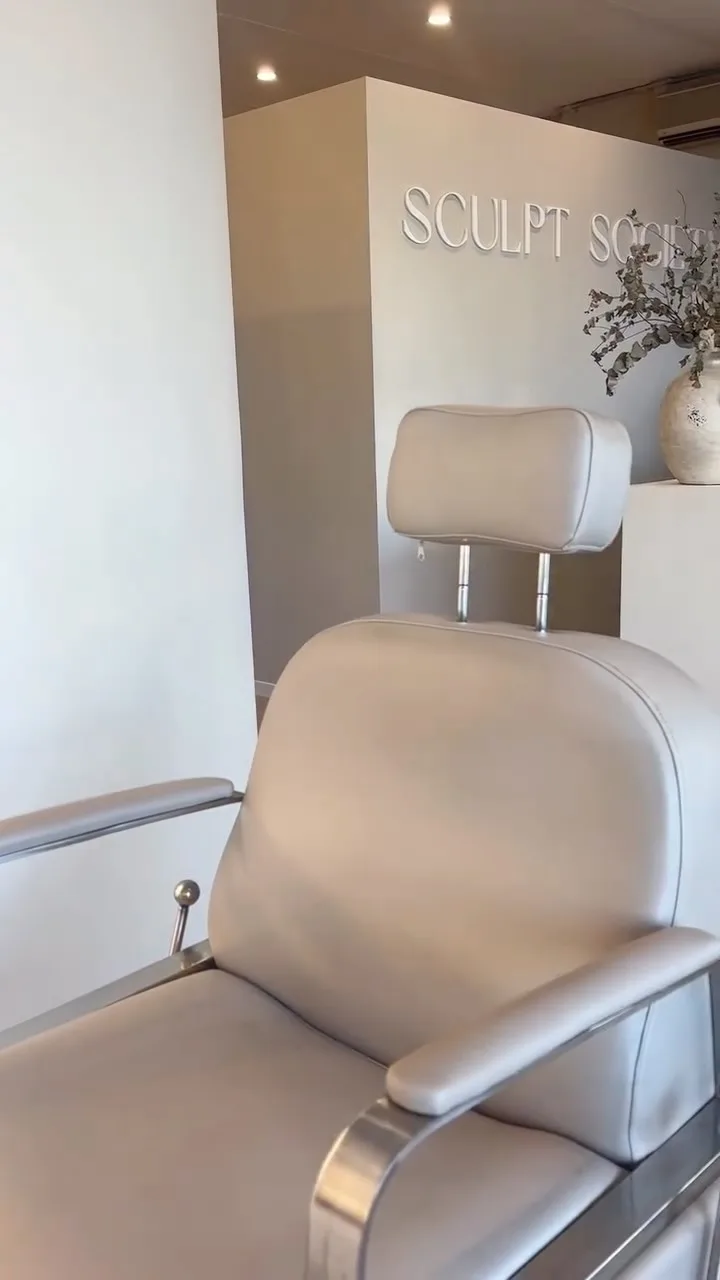 Sculpt Society treatment styling chair with partial wall signage