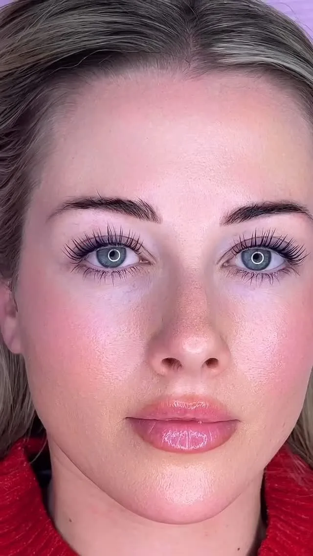 Portrait — client with defined brows and lifted lashes, red top